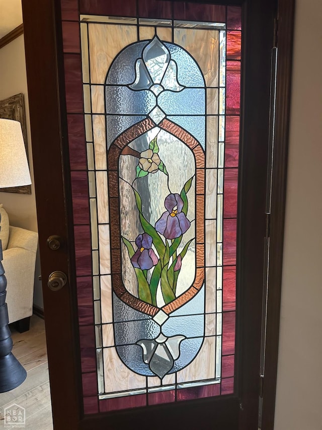 room details featuring wood finished floors and ornamental molding