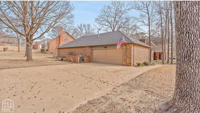 700 Oak Hollow Ln, Jonesboro, AR 72401 - view of home's exterior with brick siding, a garage, concrete driveway, and a chimney