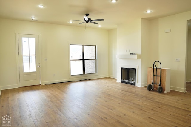 101 Clearwater Dr, Brookland, AR 72417 - unfurnished living room with a fireplace, a ceiling fan, hardwood / wood-style floors, recessed lighting, and baseboards