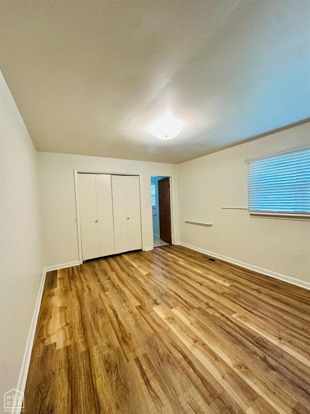 320 Church, Weiner, AR 72479 - unfurnished bedroom with baseboards, a closet, and wood finished floors