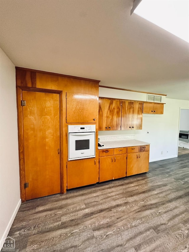 320 Church, Weiner, AR 72479 - kitchen featuring visible vents, brown cabinets, dark wood-style floors, and oven