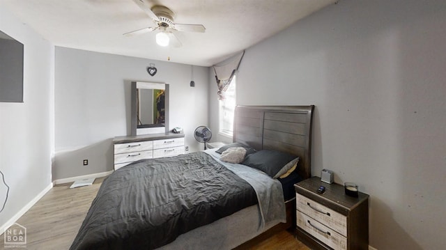 bedroom featuring wood finished floors, baseboards, and ceiling fan