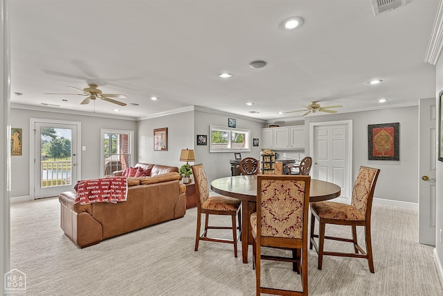 dining room with ceiling fan, light colored carpet, baseboards, recessed lighting, and crown molding