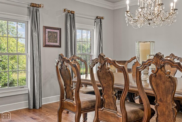 3705 Sawgrass Dr, Jonesboro, AR 72404 - dining room with baseboards, light wood finished floors, a chandelier, plenty of natural light, and crown molding