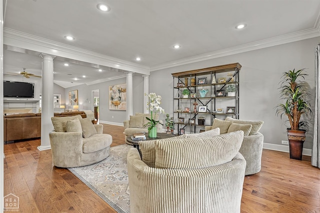 living room with decorative columns, ornamental molding, baseboards, hardwood / wood-style flooring, and recessed lighting