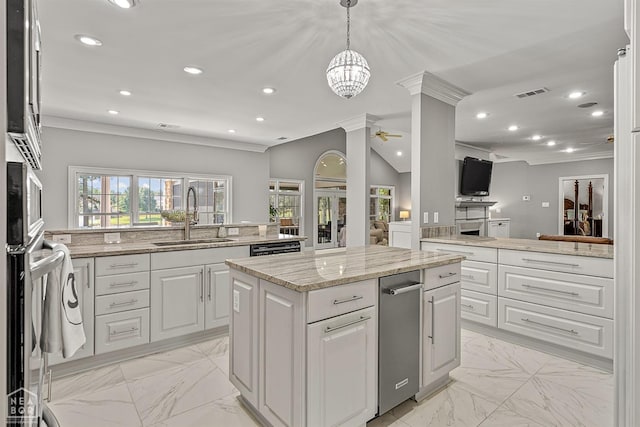 kitchen with a sink, light marble finish floors, crown molding, a kitchen island, and white cabinets
