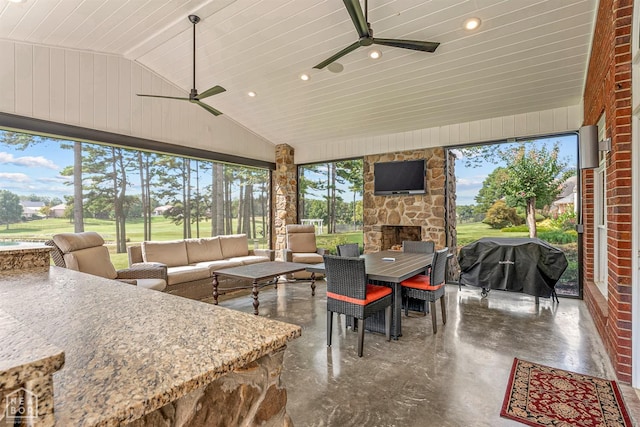 view of patio / terrace with an outdoor living space with a fireplace, outdoor dining area, a ceiling fan, and a grill