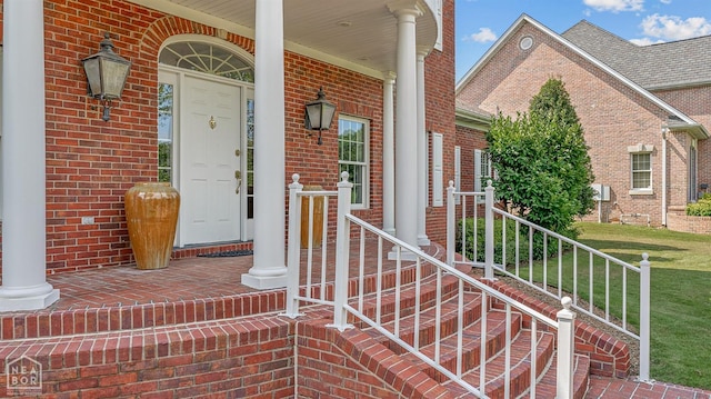 property entrance with brick siding and covered porch