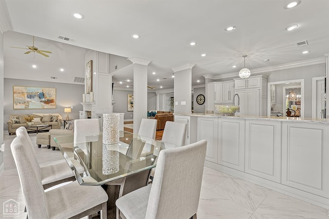 dining area with ornate columns, recessed lighting, a ceiling fan, light marble finish flooring, and crown molding