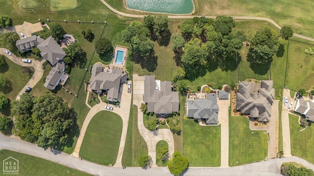 aerial view of property and surrounding area featuring nearby suburban area