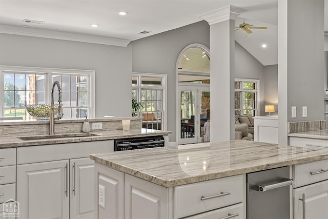 kitchen featuring a sink, recessed lighting, a ceiling fan, white cabinets, and light stone countertops