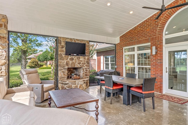 view of patio / terrace with outdoor dining area and an outdoor living space with a fireplace