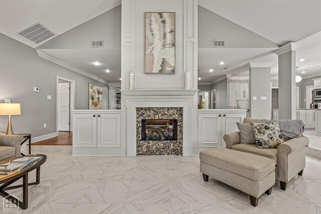 living room featuring ornamental molding, ornate columns, recessed lighting, a tile fireplace, and light marble finish flooring