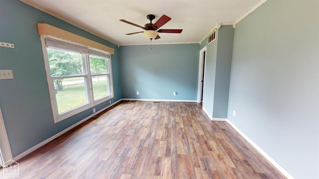 207 11th St, Marked Tree, AR 72365 - unfurnished room featuring crown molding, a ceiling fan, and wood finished floors