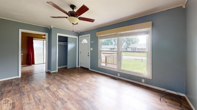 207 11th St, Marked Tree, AR 72365 - unfurnished room featuring ornamental molding, plenty of natural light, wood finished floors, and ceiling fan