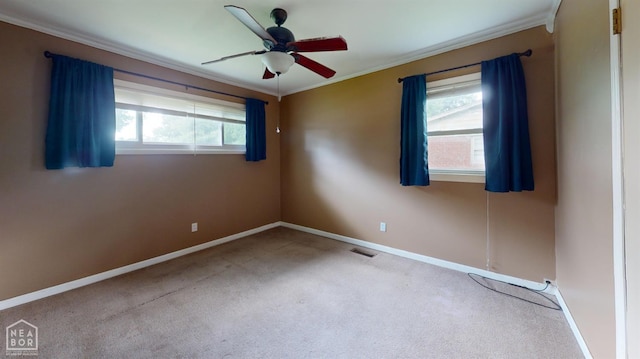 207 11th St, Marked Tree, AR 72365 - carpeted empty room featuring crown molding and a ceiling fan