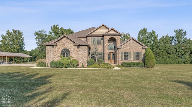 view of front facade featuring brick siding, a front lawn, metal roof, and a standing seam roof
