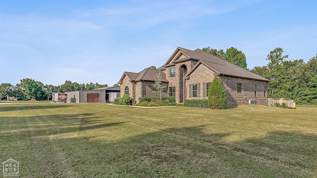 view of home's exterior with brick siding, central AC unit, a yard, and a garage