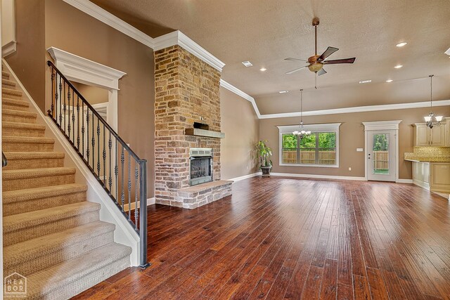 719 Smithfield Dr, Jonesboro, AR 72401 - unfurnished living room featuring ceiling fan, a fireplace, hardwood / wood-style flooring, stairway, and crown molding