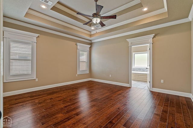 719 Smithfield Dr, Jonesboro, AR 72401 - spare room featuring healthy amount of natural light, a tray ceiling, ceiling fan, hardwood / wood-style flooring, and ornamental molding