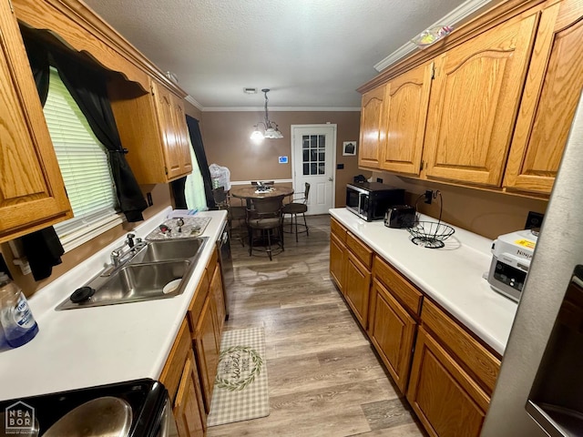 1510 Pratt Cir, Jonesboro, AR 72401 - kitchen featuring a sink, crown molding, light countertops, light wood-style floors, and brown cabinetry