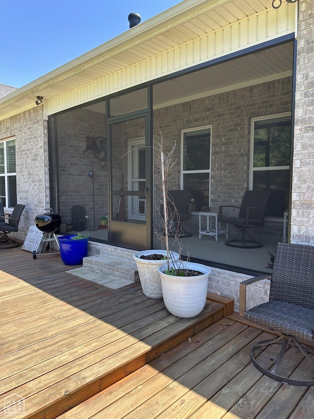105 Brayden Ln, Brookland, AR 72417 - wooden terrace featuring a sunroom and grilling area