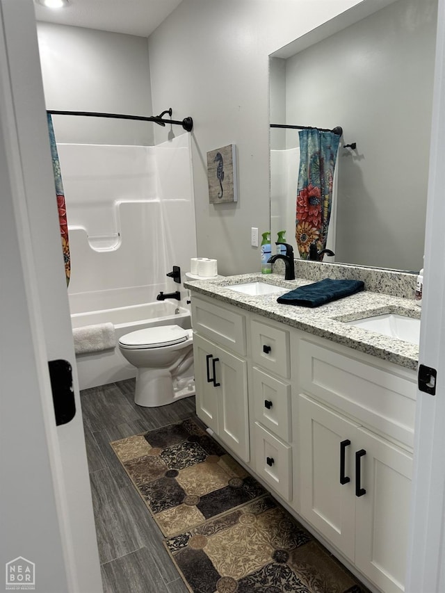 105 Brayden Ln, Brookland, AR 72417 - bathroom featuring double vanity, toilet, shower / bath combo, and wood finished floors