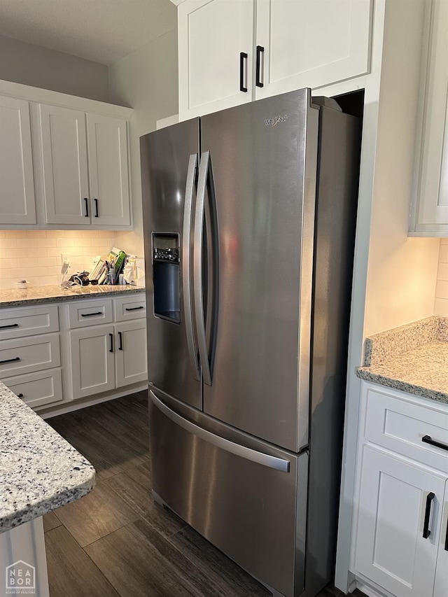 105 Brayden Ln, Brookland, AR 72417 - kitchen featuring stainless steel fridge with ice dispenser, dark wood finished floors, white cabinets, and decorative backsplash