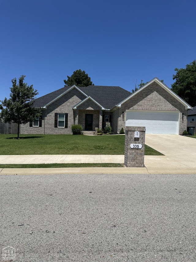 105 Brayden Ln, Brookland, AR 72417 - single story home with a garage, concrete driveway, a front lawn, and brick siding