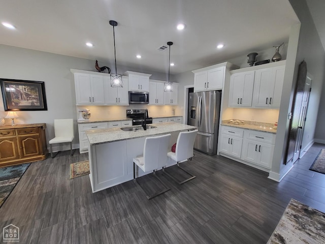 105 Brayden Ln, Brookland, AR 72417 - kitchen with stainless steel appliances, a sink, a kitchen island with sink, white cabinets, and recessed lighting
