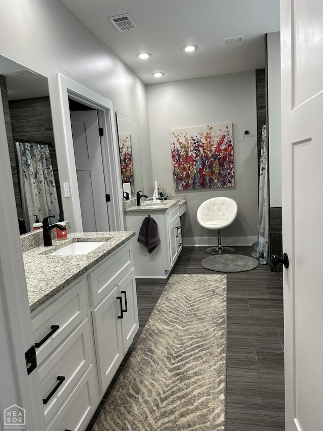 105 Brayden Ln, Brookland, AR 72417 - bathroom featuring two vanities, recessed lighting, and wood finished floors
