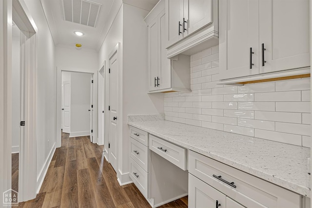 3425 Hudson Ct, Jonesboro, AR 72405 - kitchen with dark wood finished floors, white cabinetry, decorative backsplash, light stone counters, and baseboards