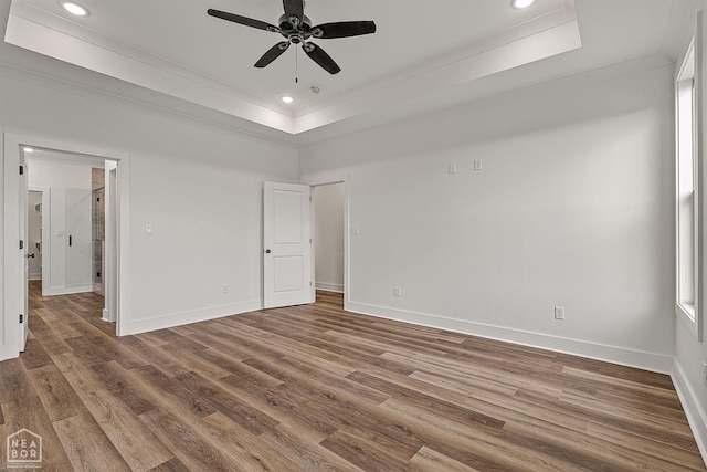 3425 Hudson Ct, Jonesboro, AR 72405 - unfurnished bedroom with crown molding, a tray ceiling, wood finished floors, baseboards, and recessed lighting