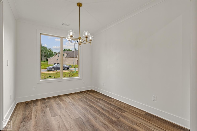 3425 Hudson Ct, Jonesboro, AR 72405 - spare room with a chandelier, crown molding, dark wood-type flooring, and baseboards
