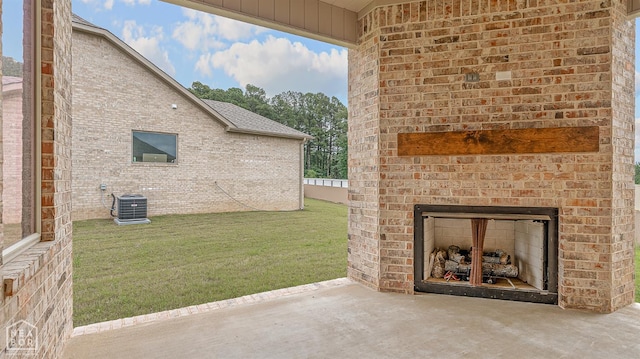 3425 Hudson Ct, Jonesboro, AR 72405 - view of green lawn with an outdoor brick fireplace, cooling unit, concrete driveway, a patio, and an attached garage