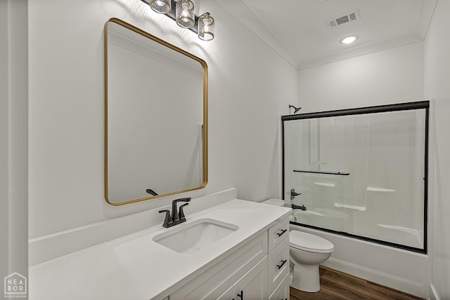 3425 Hudson Ct, Jonesboro, AR 72405 - bathroom with vanity, toilet, wood finished floors, shower / bath combination with glass door, and ornamental molding