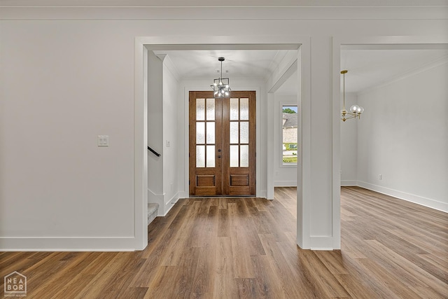3425 Hudson Ct, Jonesboro, AR 72405 - entrance foyer with ornamental molding, a chandelier, wood finished floors, baseboards, and french doors