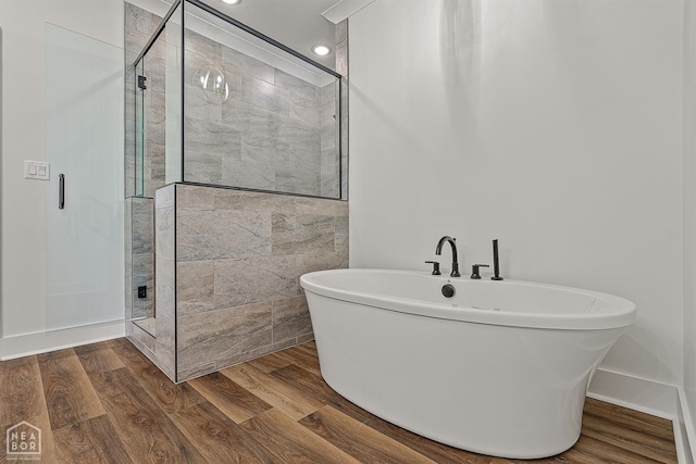3425 Hudson Ct, Jonesboro, AR 72405 - full bath featuring a freestanding bath, a stall shower, and wood finished floors