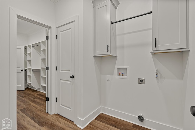 3425 Hudson Ct, Jonesboro, AR 72405 - washroom with electric dryer hookup, washer hookup, wood finished floors, baseboards, and cabinet space