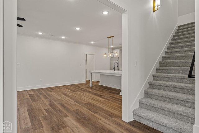 3425 Hudson Ct, Jonesboro, AR 72405 - basement featuring stairs, dark wood-type flooring, crown molding, recessed lighting, and baseboards