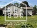 812 E Unity Rd E, Paragould, AR 72450 - view of home's exterior featuring a lawn