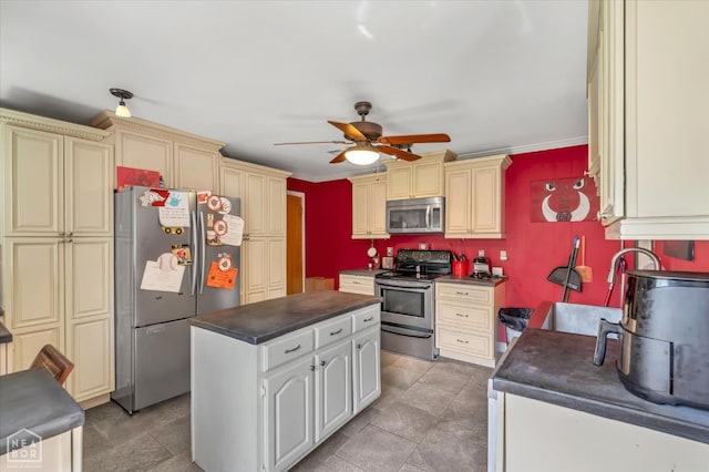 316 SE 2nd St SE, Walnut Ridge, AR 72476 - kitchen with appliances with stainless steel finishes, cream cabinets, dark countertops, ceiling fan, and crown molding