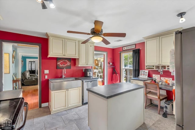 316 SE 2nd St SE, Walnut Ridge, AR 72476 - kitchen with cream cabinets, appliances with stainless steel finishes, ceiling fan, dark countertops, and ornamental molding