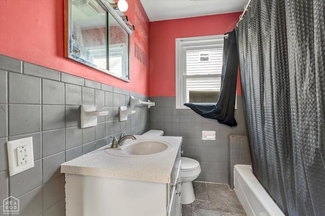 316 SE 2nd St SE, Walnut Ridge, AR 72476 - bathroom featuring tile walls, vanity, shower / bathtub combination with curtain, a wainscoted wall, and tile patterned flooring