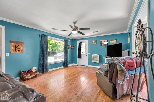 316 SE 2nd St SE, Walnut Ridge, AR 72476 - living room with ceiling fan, heating unit, hardwood / wood-style floors, and crown molding