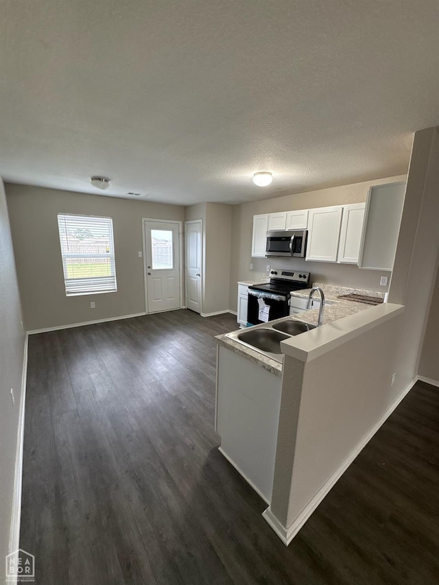 3726 Glitterman Dr, Jonesboro, AR 72404 - kitchen with stainless steel microwave, electric stove, and baseboards