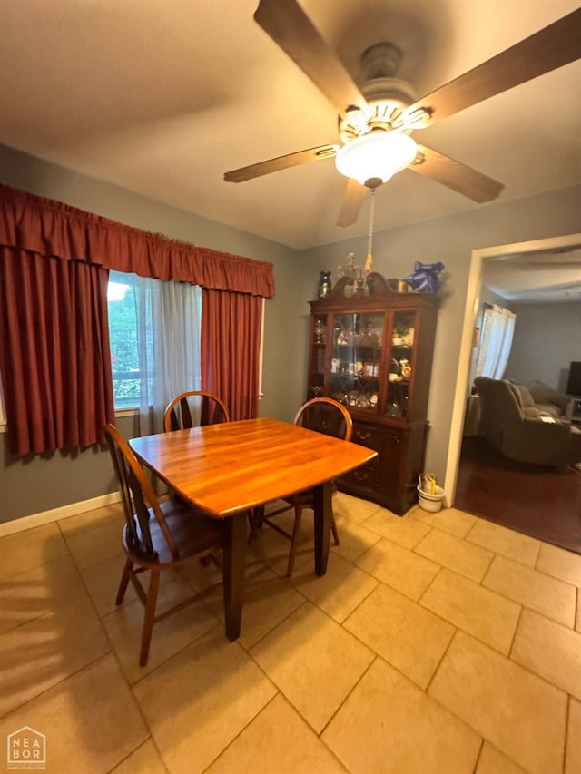 dining space featuring a ceiling fan and light tile patterned flooring