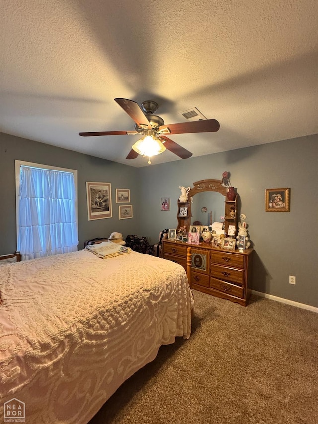 carpeted bedroom with a ceiling fan, a textured ceiling, visible vents, and baseboards