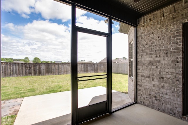 doorway to outside featuring brick wall