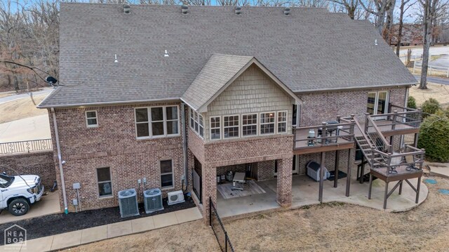 3506 Cedar Creek Cv, Jonesboro, AR 72404 - back of house with central AC unit, brick siding, stairway, a deck, and a patio